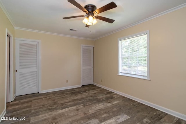 13128 Hanover Dr, Ocean Springs, MS 39564 - unfurnished bedroom featuring two closets, crown molding, wood finished floors, and ceiling fan