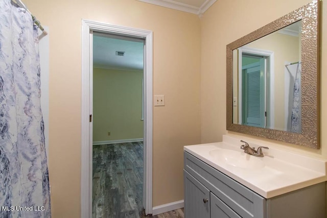 13128 Hanover Dr, Ocean Springs, MS 39564 - full bathroom featuring crown molding, vanity, wood finished floors, and curtained shower
