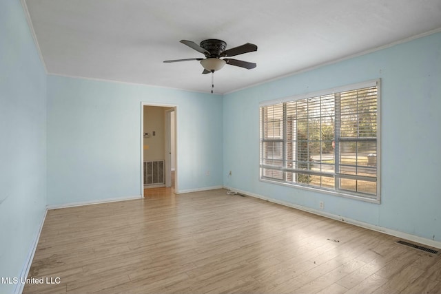 unfurnished room with crown molding, visible vents, ceiling fan, and wood finished floors