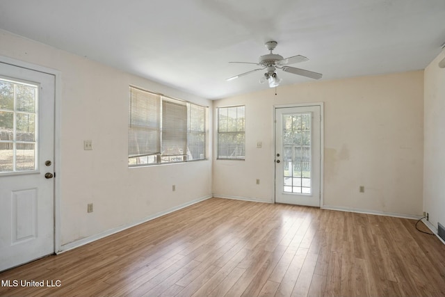 interior space featuring ceiling fan, baseboards, and wood finished floors