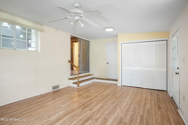 unfurnished bedroom with light wood finished floors, a closet, visible vents, ceiling fan, and baseboards