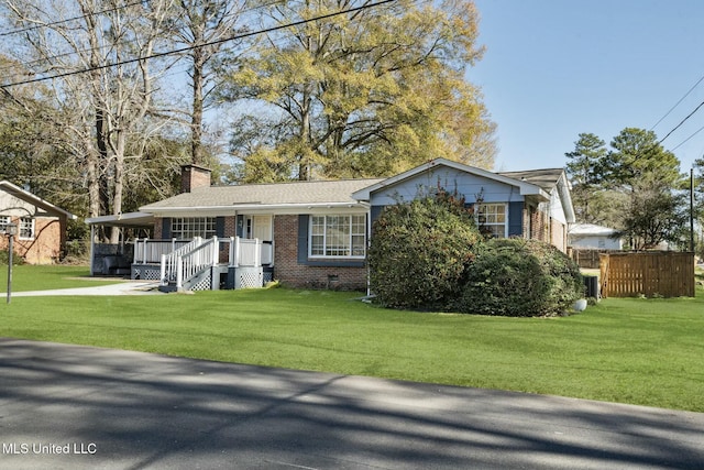 ranch-style house with a chimney, an attached carport, crawl space, a front lawn, and brick siding