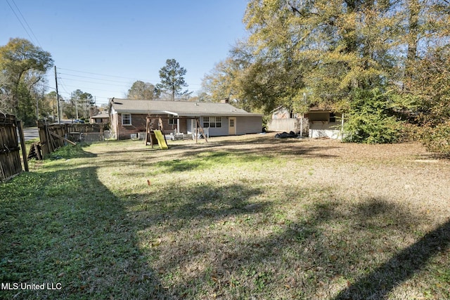 rear view of house with a yard, a patio area, and fence