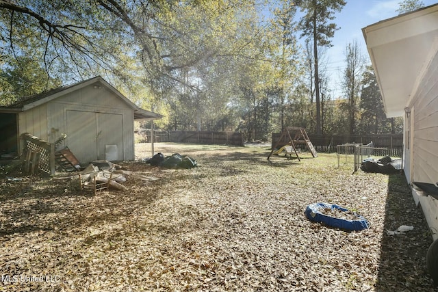 view of yard with a shed, a playground, a fenced backyard, and an outdoor structure