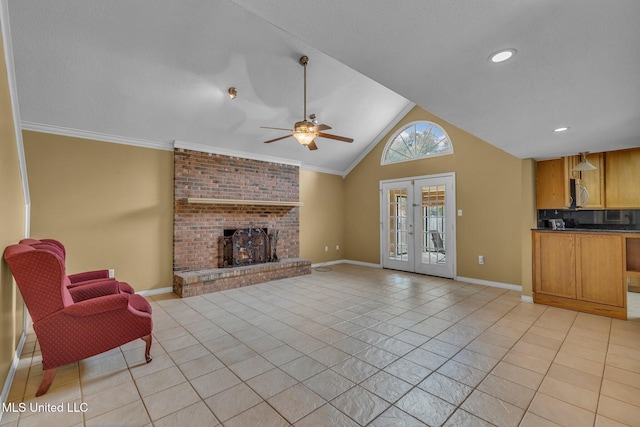 living area with a brick fireplace, baseboards, lofted ceiling, light tile patterned floors, and french doors