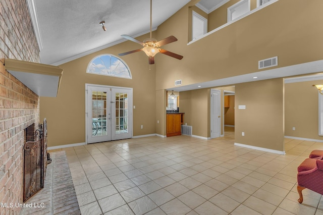 unfurnished living room with visible vents, a brick fireplace, baseboards, french doors, and light tile patterned flooring