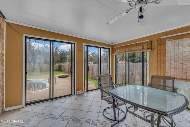 unfurnished sunroom featuring a ceiling fan