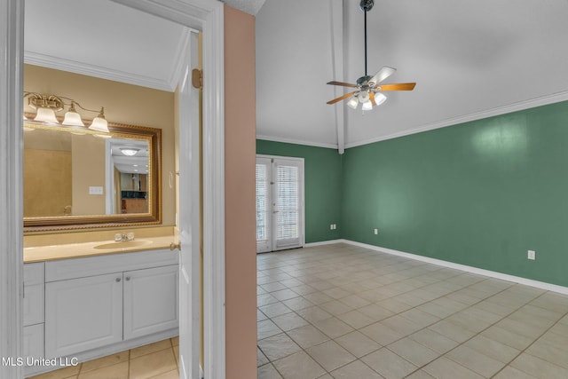 bathroom with baseboards, lofted ceiling, ceiling fan, tile patterned flooring, and ornamental molding