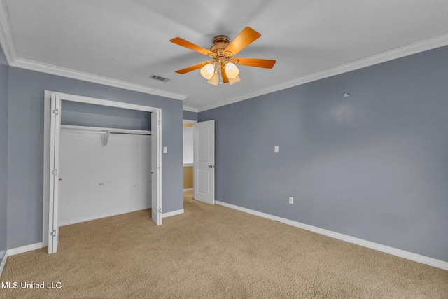 unfurnished bedroom featuring crown molding, baseboards, visible vents, and a closet