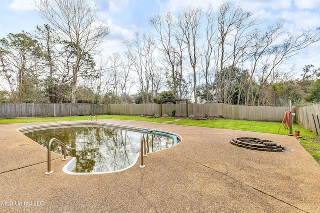 view of pool featuring a patio, a fenced in pool, an outdoor fire pit, a yard, and a fenced backyard