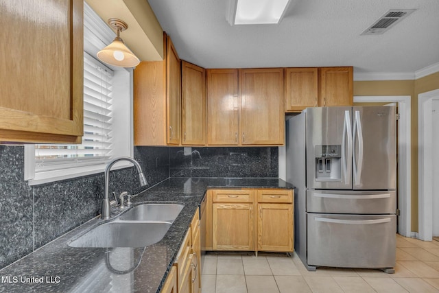 kitchen with visible vents, stainless steel refrigerator with ice dispenser, a sink, tasteful backsplash, and light tile patterned floors