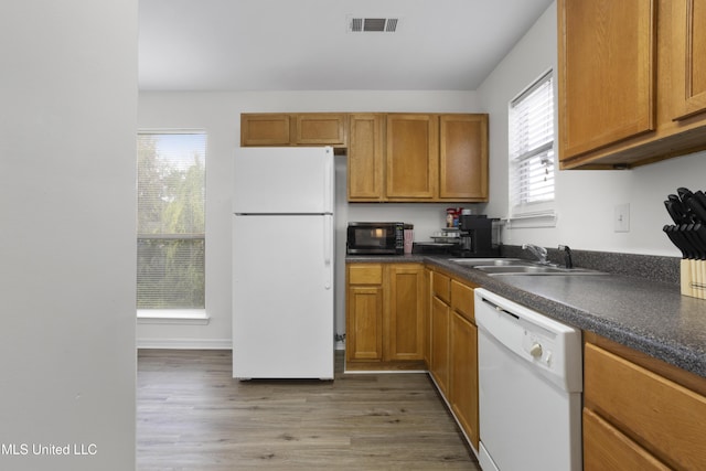 kitchen featuring white appliances, dark hardwood / wood-style floors, and sink