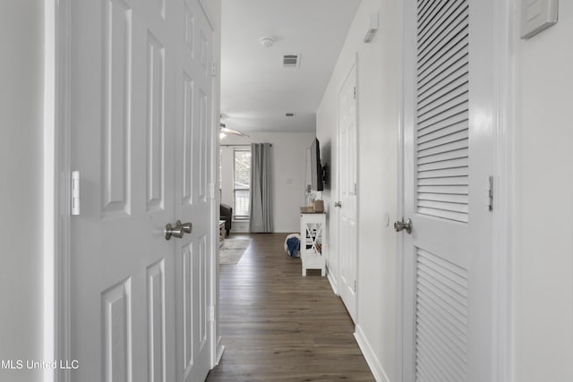 corridor featuring dark hardwood / wood-style floors