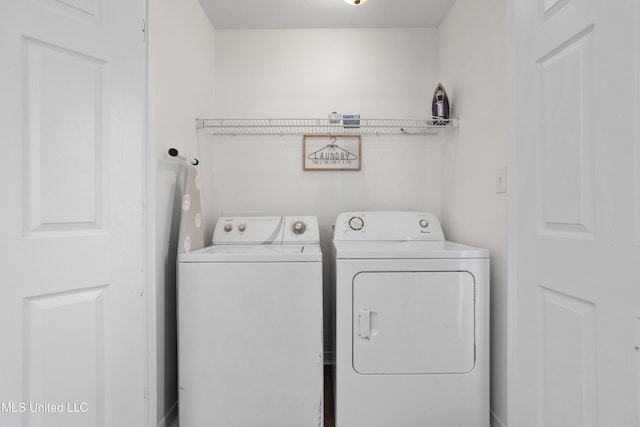 clothes washing area with separate washer and dryer