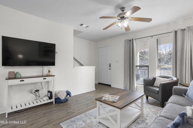 living room with ceiling fan and hardwood / wood-style floors