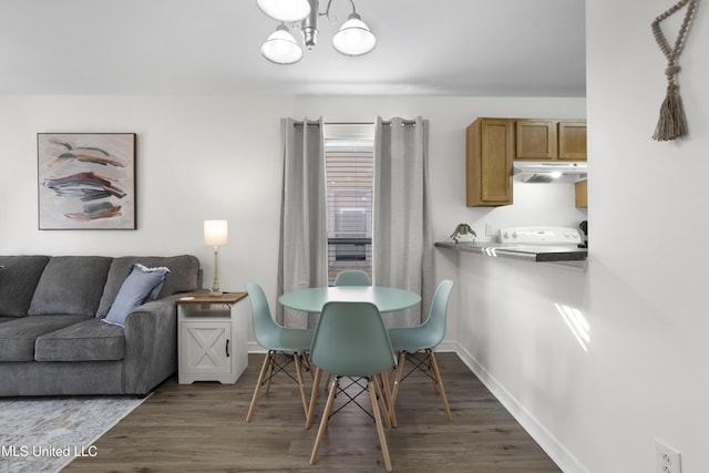 dining space with a notable chandelier and dark hardwood / wood-style flooring