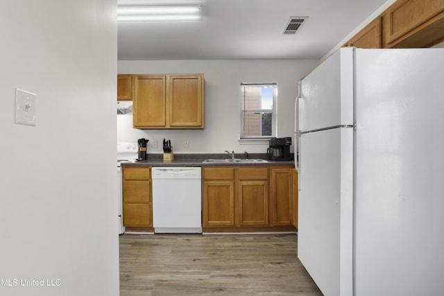 kitchen with white appliances, light hardwood / wood-style flooring, and sink