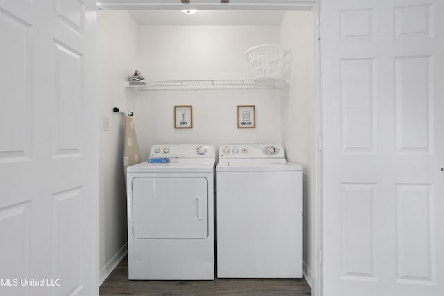 clothes washing area featuring washing machine and dryer and dark hardwood / wood-style flooring