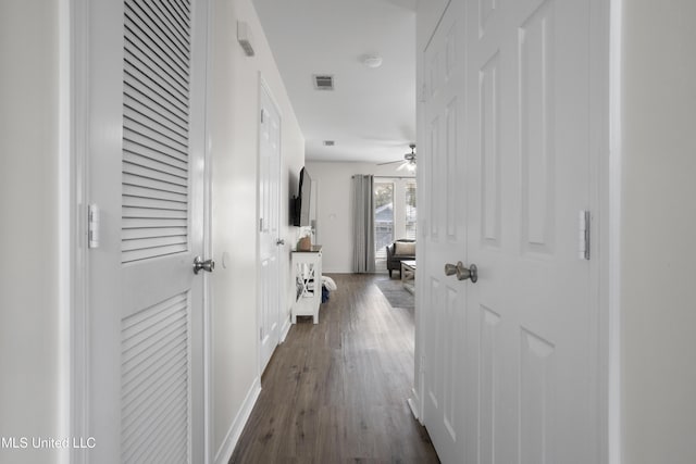 corridor with dark hardwood / wood-style flooring