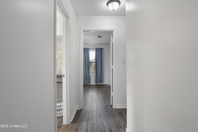 corridor with wood-type flooring