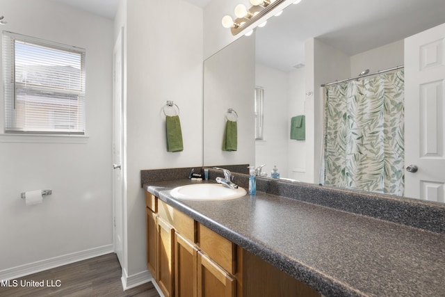 bathroom with hardwood / wood-style floors and vanity