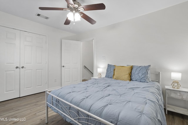 bedroom with ceiling fan, a closet, and wood-type flooring