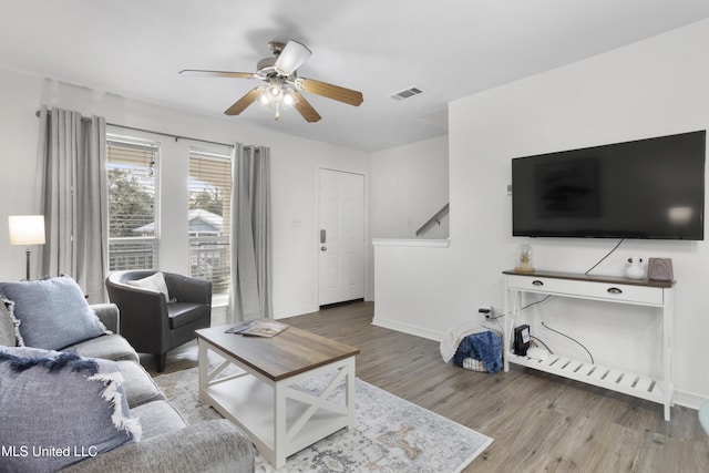 living room featuring hardwood / wood-style flooring and ceiling fan