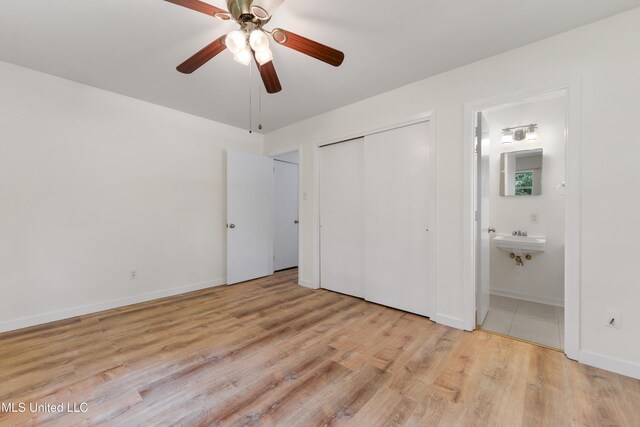 205 Walnut Dr, Ocean Springs, MS 39564 - unfurnished bedroom with wood finished floors, ensuite bathroom, and ceiling fan