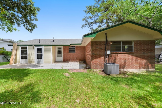 205 Walnut Dr, Ocean Springs, MS 39564 - back of house with a patio, a yard, and brick siding