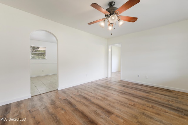 205 Walnut Dr, Ocean Springs, MS 39564 - unfurnished room featuring ceiling fan, arched walkways, and wood finished floors