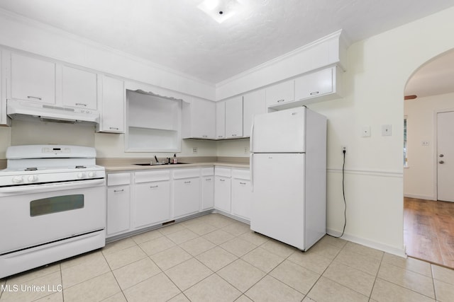 205 Walnut Dr, Ocean Springs, MS 39564 - kitchen featuring white appliances, under cabinet range hood, arched walkways, light countertops, and white cabinets