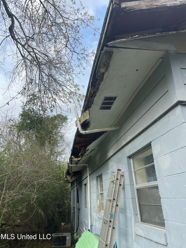 view of side of home featuring cooling unit