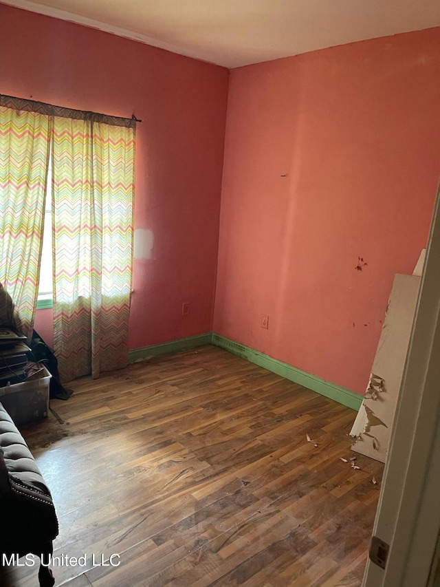 unfurnished room featuring dark wood-type flooring