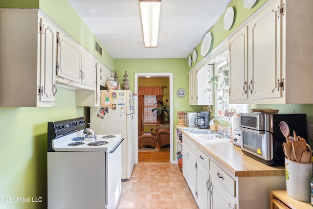 1825 Brookhaven Dr, Southaven, MS 38671 - kitchen featuring white appliances, light countertops, and white cabinets
