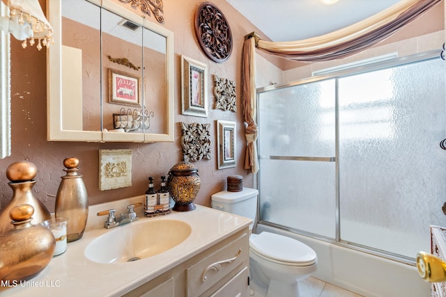 1825 Brookhaven Dr, Southaven, MS 38671 - full bathroom featuring vanity, combined bath / shower with glass door, a textured wall, and tile patterned flooring