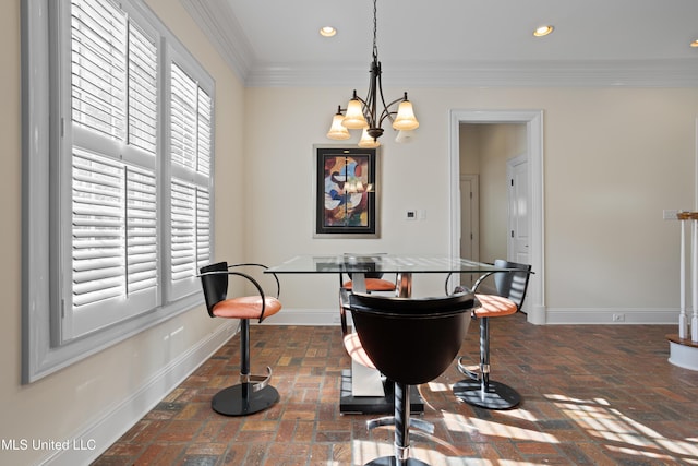 dining area featuring ornamental molding and an inviting chandelier