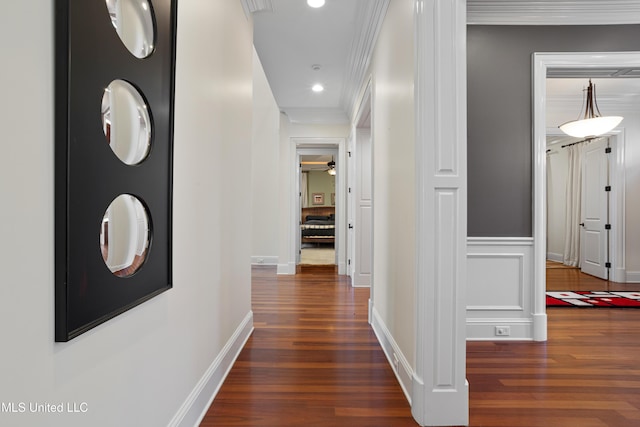 corridor featuring ornamental molding and dark wood-type flooring