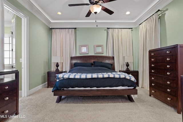 carpeted bedroom featuring ceiling fan and crown molding