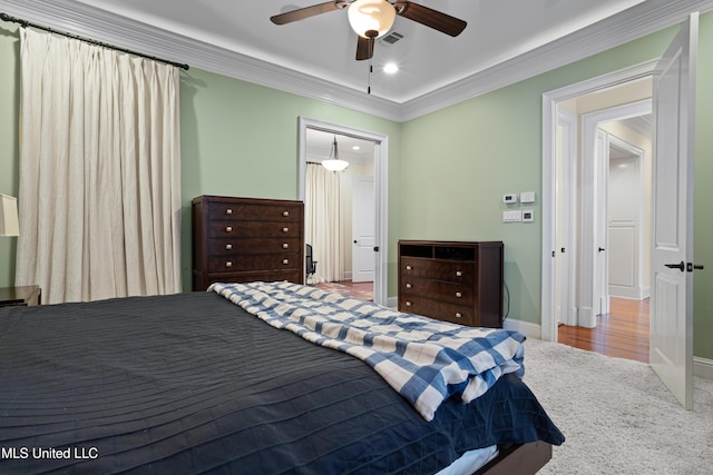 bedroom with carpet floors, ceiling fan, and crown molding