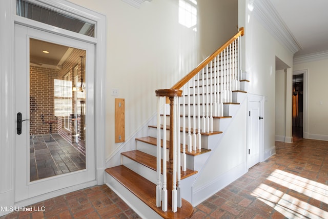 stairs featuring crown molding