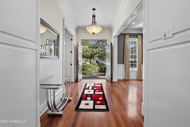 foyer featuring hardwood / wood-style floors, plenty of natural light, and ornamental molding