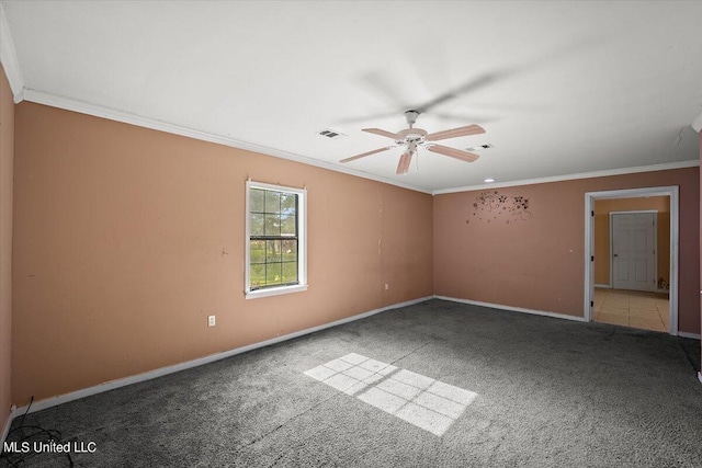 empty room featuring ceiling fan, carpet floors, crown molding, and baseboards
