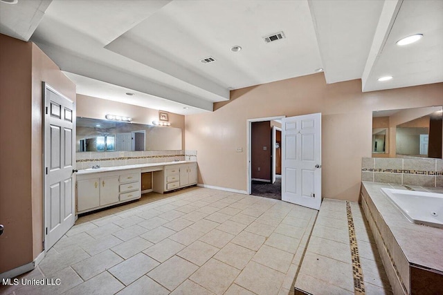 bathroom featuring a bath, visible vents, vanity, and baseboards