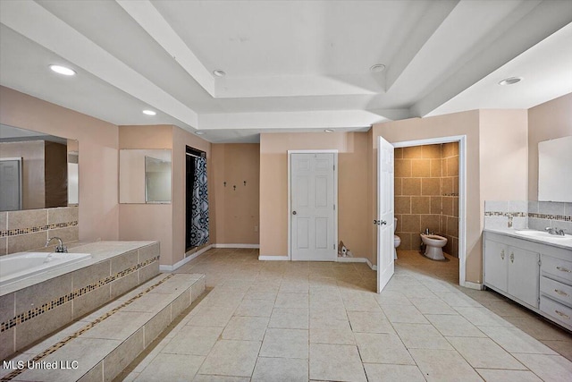 full bath with a garden tub, tile patterned floors, vanity, a tray ceiling, and a bidet