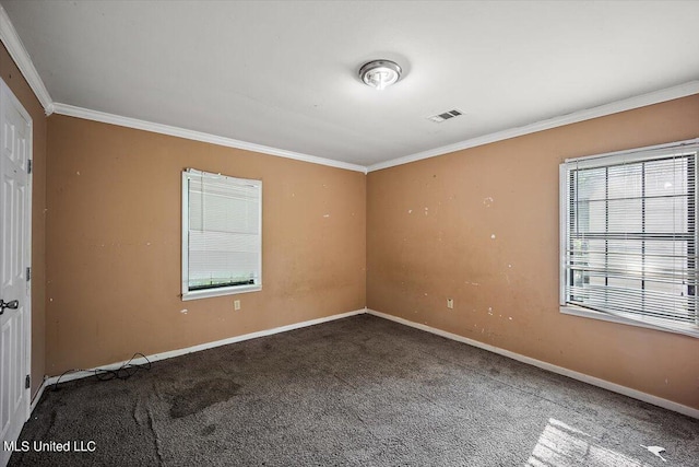 carpeted empty room featuring visible vents, baseboards, and ornamental molding