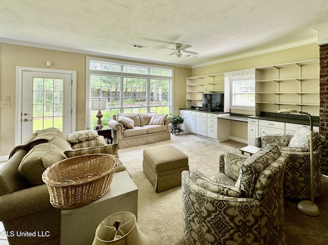 living area with visible vents, crown molding, ceiling fan, and light carpet