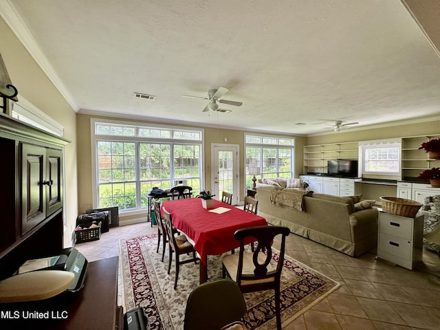tiled dining room featuring a ceiling fan, visible vents, and ornamental molding