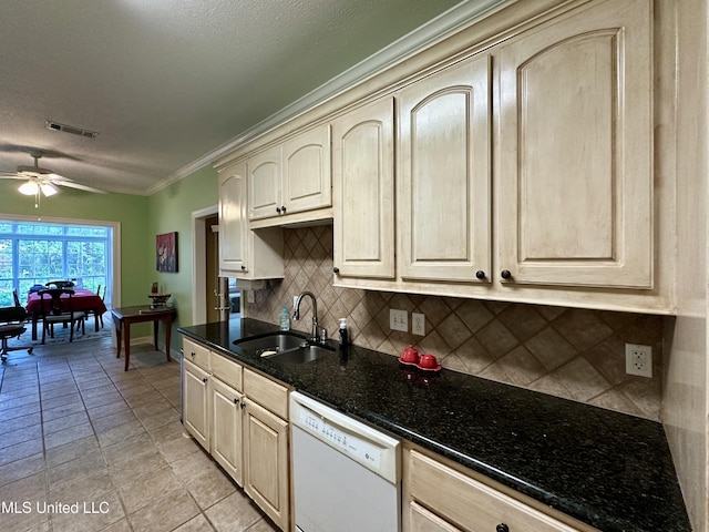 kitchen featuring cream cabinets, white dishwasher, ceiling fan, a sink, and visible vents