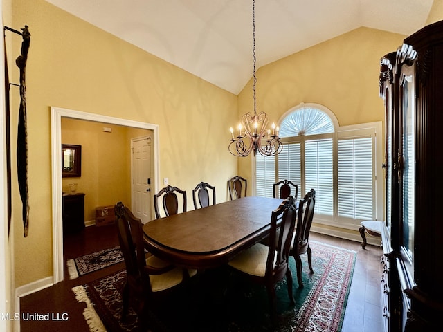 dining space with an inviting chandelier, high vaulted ceiling, and baseboards