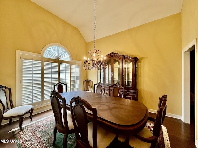 dining area featuring high vaulted ceiling, baseboards, and a notable chandelier